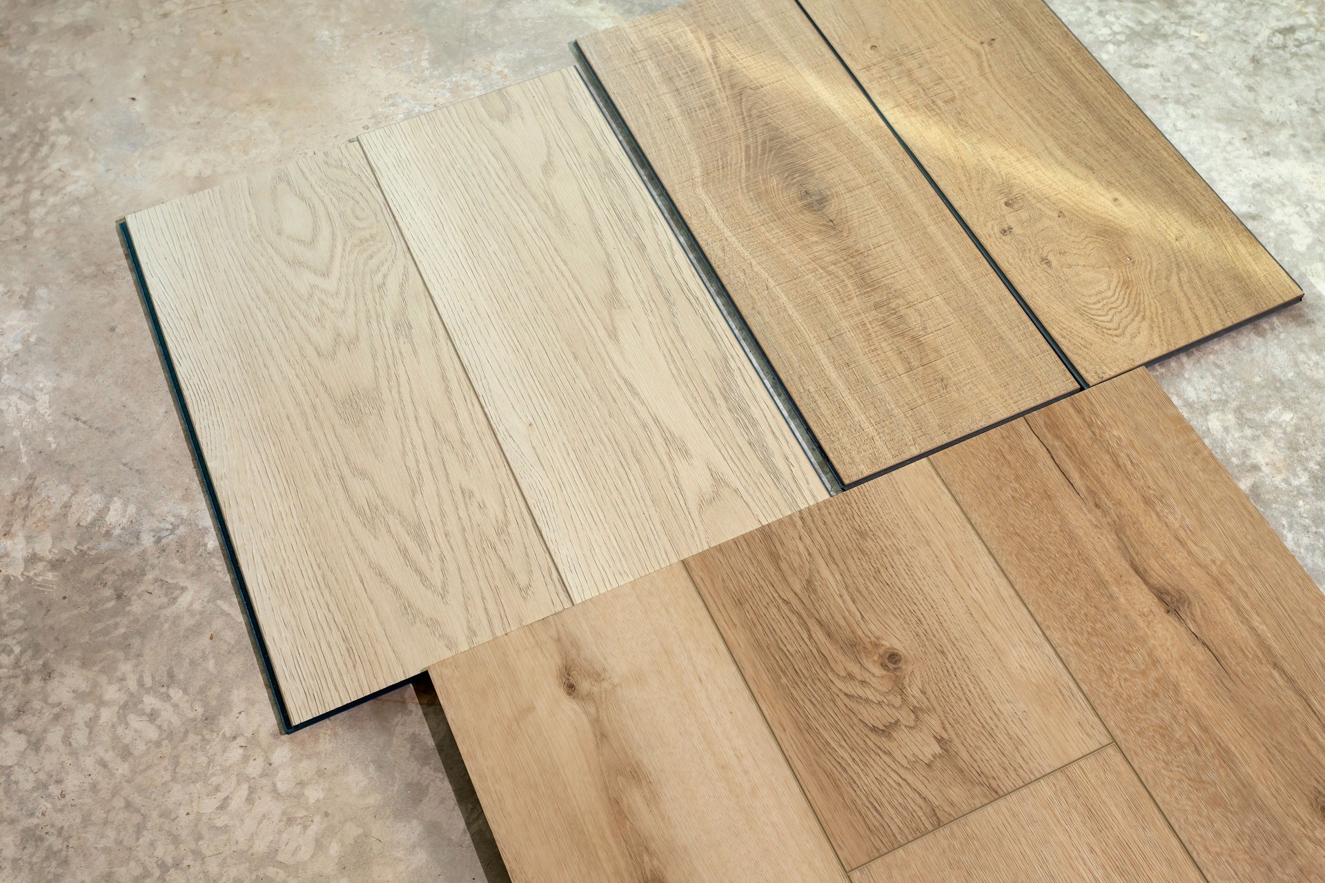 Top View Luxury Vinyl Wood Samples Lying On Concrete Floor In House. Choosing, Selecting Waterproof Flooring. Home Reconstruction. Vinyl Tiles Collection, Patterns. Interior Design Idea. Horizontal.